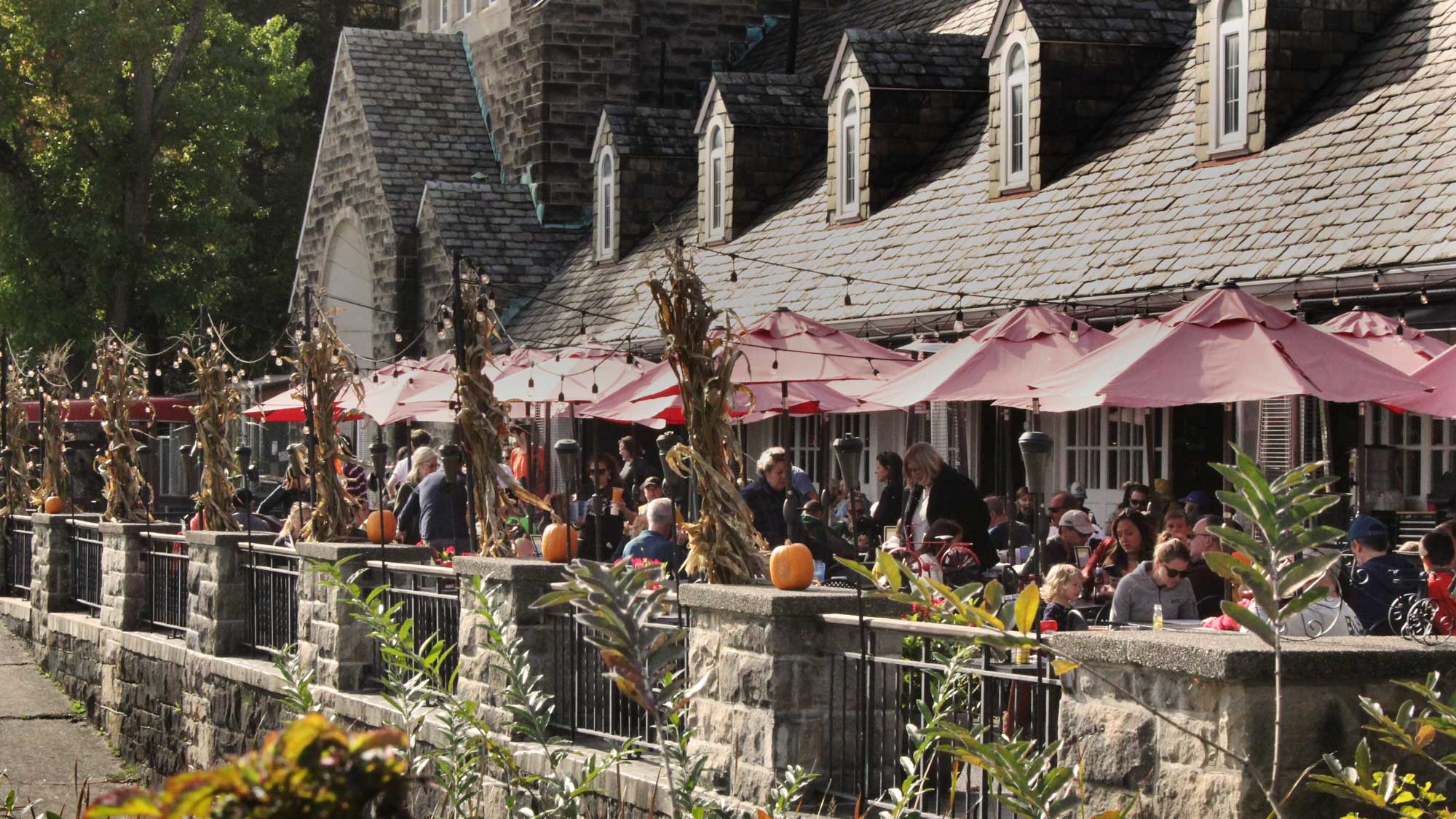 Crowd of people under umbrella tables