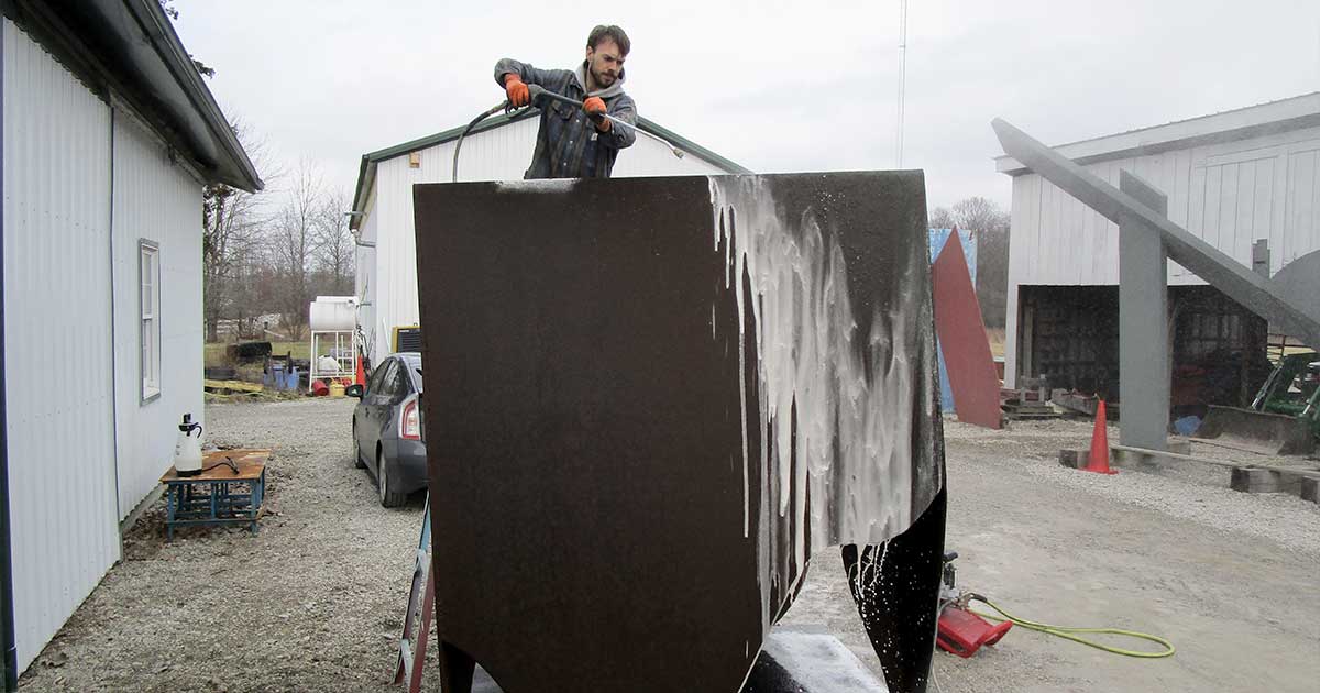 Man sprays sculpture