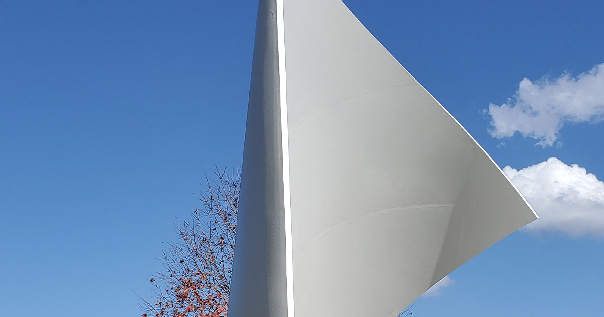 large metal sculpture that looks like a sail