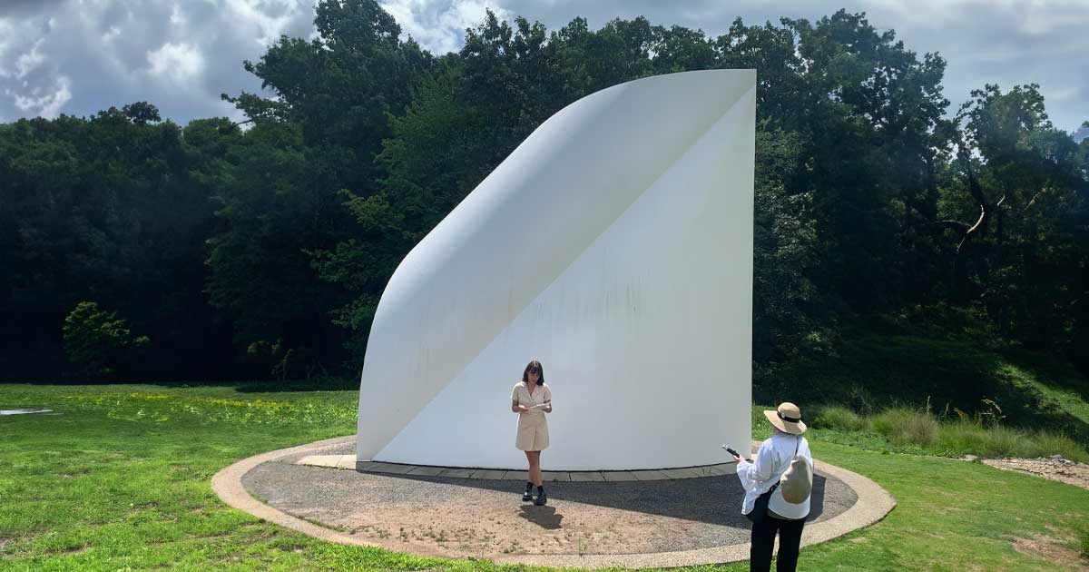 Student standing in front of David von Schlegell’s North Light, 1982 during the public walking tour conducted of the site