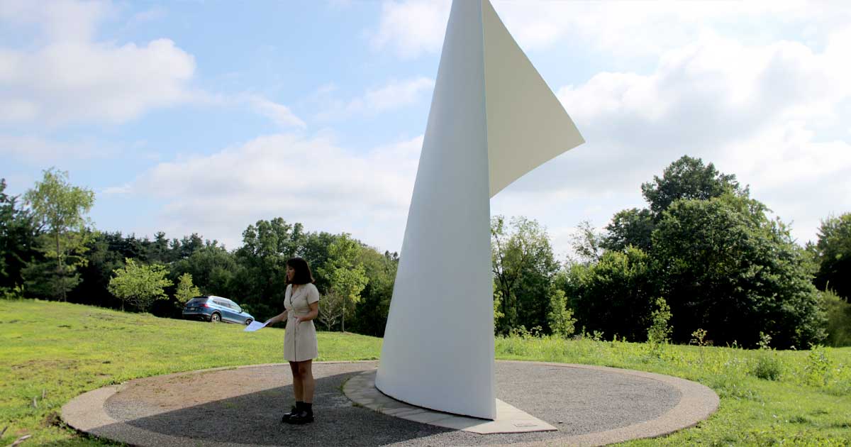 Layne standing in front of David von Schlegell’s North Light, 1982 during the public walking tour conducted of the site
