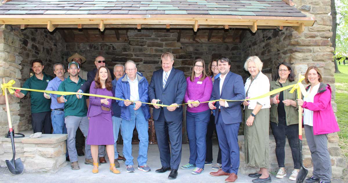 Group cutting ribbon at Nevin shelter