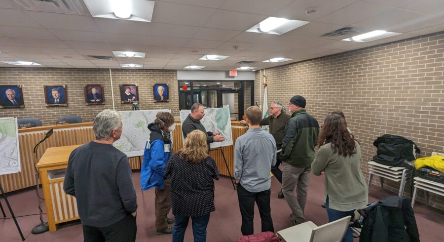 Group at meeting looking at a project board.