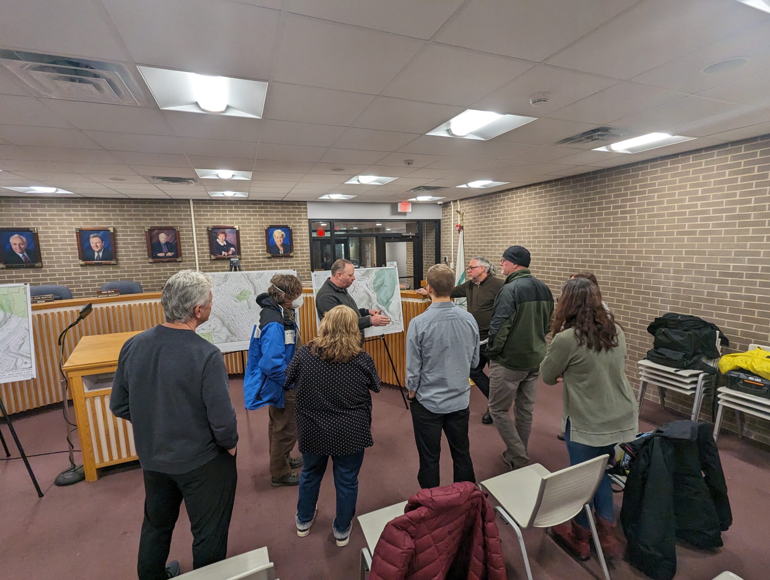 Group at meeting looking at a project board.